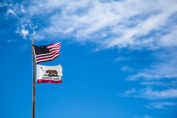 California and US flags in the sky on Bodie State Park, California