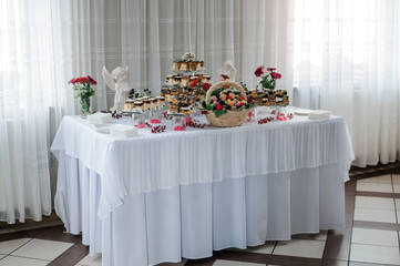 Sweet cakes at a wedding banquet. Catering, sweet festive buffet. Candy bar