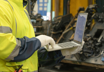 Black African American man, an engineer or worker using a laptop notebook computer device to...