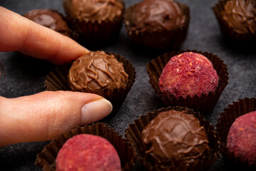 woman hand taking chocolate candy