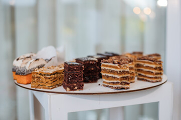 Sweet cakes at a wedding banquet. Catering, sweet festive buffet. Candy bar