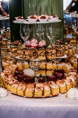 Sweet cakes at a wedding banquet. Catering, sweet festive buffet. Candy bar