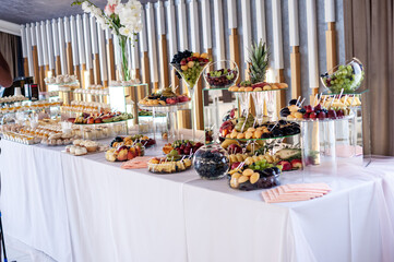 Sweet cakes at a wedding banquet. Catering, sweet festive buffet. Candy bar