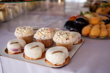 Sweet cakes at a wedding banquet. Catering, sweet festive buffet. Candy bar