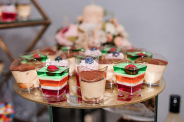 Sweet cakes at a wedding banquet. Catering, sweet festive buffet. Candy bar