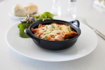 Dish of Lasagna and Side Salad