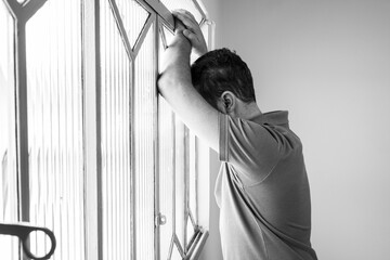 Man with depression looking out the window