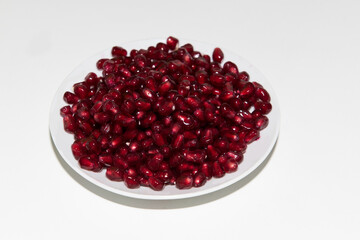 Garnet seeds in white plate
