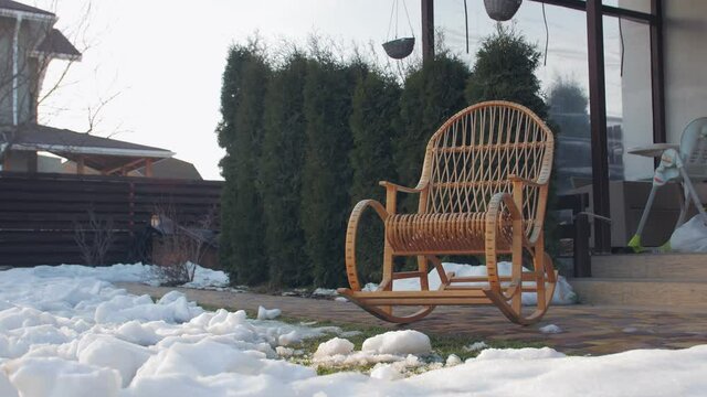 Rocking chair backyard winter snow push in forward camera movement