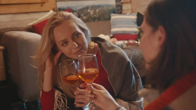 Best friend relaxing in the cozy home and drinking mulled wine. High quality 4k footage
