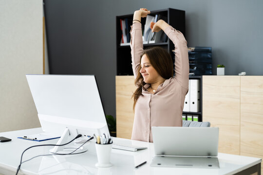 Woman Stretching At Office Desk