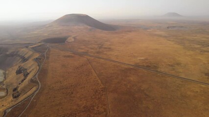 Aerial view of volcanic cone on Mars. Exploring mountain landscapes of red planet for a space ship. Outer space exploration and colonization concept. - Powered by Adobe