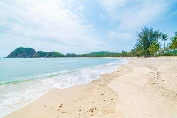 Secluded tropical beach turquoise transparent water palm trees, Bai Om undeveloped bay Quy Nhon Vietnam central coast travel destination, desert white sand beach