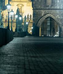 .Charles bridge. Lamps on the empty Charles Bridge on the Vltava river at night and the stone...