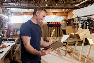 Designer using digital tablet by prototypes of table lamps
