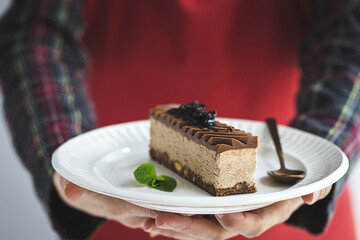 Unrecognizable woman hands with plate of French pastries