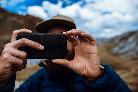 Hiker taking picture with phone, Mineral King, California, United States