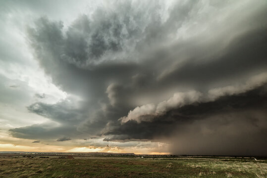 Tornadic supercell in western Oklahoma creates a dramatic landscape scene. Massive hail and small tornado during storm, USA