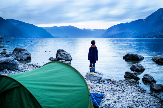 Boy looking out over lake, rear view, Lake Como, Onno, Lombardy, Italy
