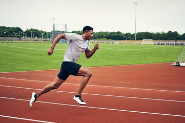 Runner training on running track