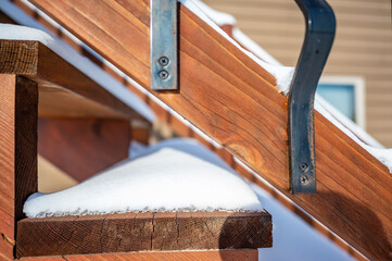 Snow covered wooden steps on a residential house