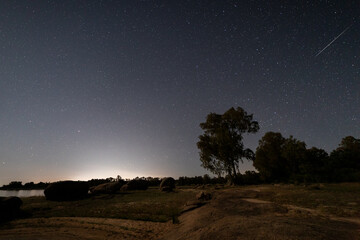 Night landscape with a shooting star in Valdesalor.. Extremadura. Spain.