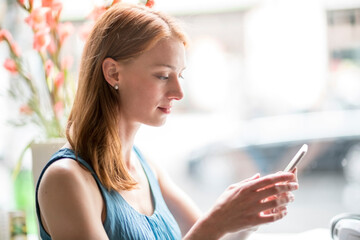 Woman using smartphone in office