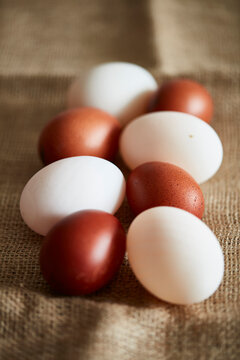 White and brown eggs on linen cloth
