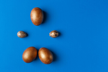 Golden modern easter eggs on a blue background. Easter concept. Isolated.