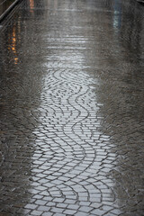 Rain on a cobblestone pavement