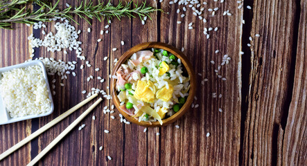 Rice three delights, in a wooden bowl. Rustic wooden table. Copy space.