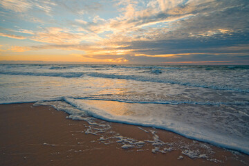 Colorful ocean beach sunset and beautiful cloudscape