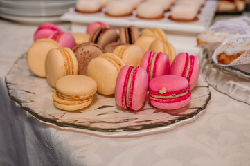 Candy bar with sweet macaroon cakes at a wedding buffet