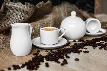 Obraz na płótnie Canvas white cup, coffee beans, espresso, dark background