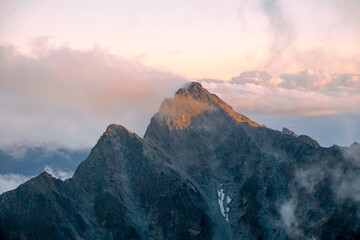 夕陽を浴びる北アルプス、北穂高岳山頂直下北穂高小屋より前穂高岳。雲海、マジックアワー。モルゲンロー。