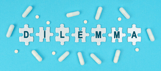 On a blue background, there are pills and puzzles with the inscription - DILEMMA