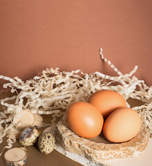 Chicken and quail eggs on a brown background. Close-up close-up. The concept of preparing for the Easter holiday. Selective focus.