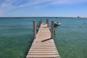 Fototapeta na wymiar wooden pier on famous beach pampelonne in saint-tropez