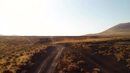 First person view of Mars rover robot moving on a road near volcanic cone on red planet. Exploring martian desert landscapes and outer space from a space ship - Powered by Adobe