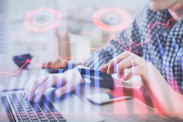 Double exposure of man hands holding a credit card and Forex graph drawing. Stock trading and digital fintech in Internet E-commerce concept.