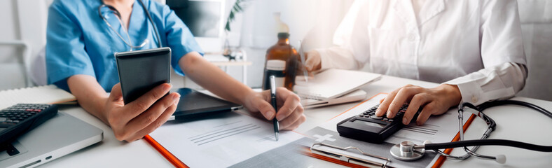Medical technology concept The doctor works with mobile phones, headphones and tablets. Digital laptop Pressing the calculator in the modern office at the hospital in the morning