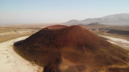 Flying towards a volcanic cone on Mars. Aerial view of crater on red planet - Powered by Adobe