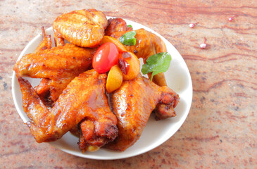 fried barbecue chicken wings marinated in spices with hot pepper and lemon.