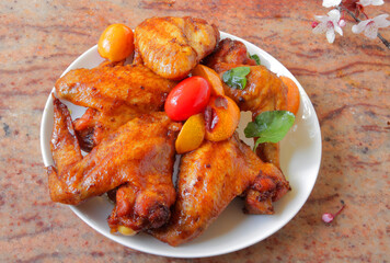 fried barbecue chicken wings marinated in spices with hot pepper and lemon.