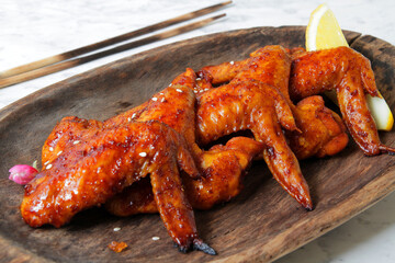 fried barbecue chicken wings marinated in spices with hot pepper and lemon.