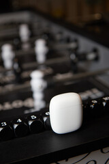 wireless headphones on the table for the board game table football blurred background