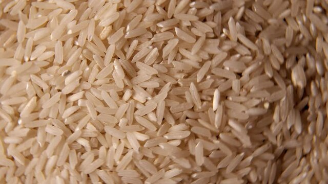 A close-up of a large amount of small white rice spinning on a plate. Healthy food concept