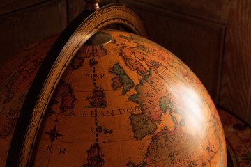 Ancient style globe before aged wooden panelling 