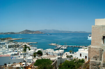 Obraz premium Naxos island Greece. Port view from the old town. Dramatic high angle landscape view over the beautiful harbor and bay. Blue sky provides copy space.