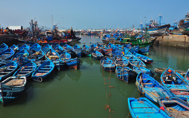 Marine scene of blue fishing boat in harbor. Blue fishing boats in harbor for tourism purposes at Essaouira, Morocco.